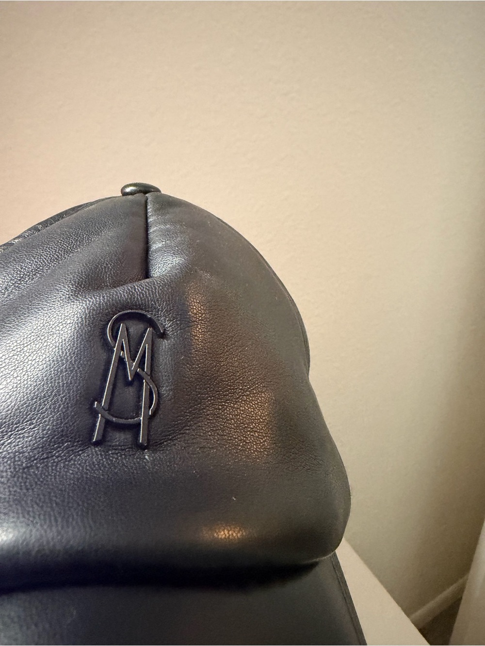 Womenβs Black Leather Backpack with Raised Monogram Detail